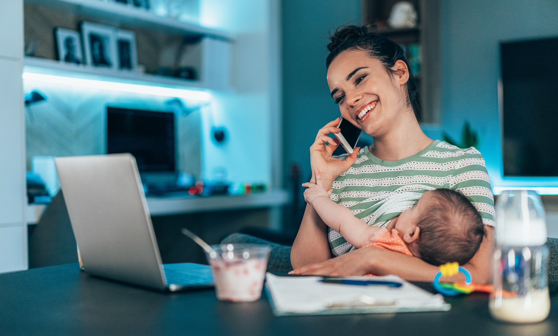 Mother breastfeeding and talking on phone