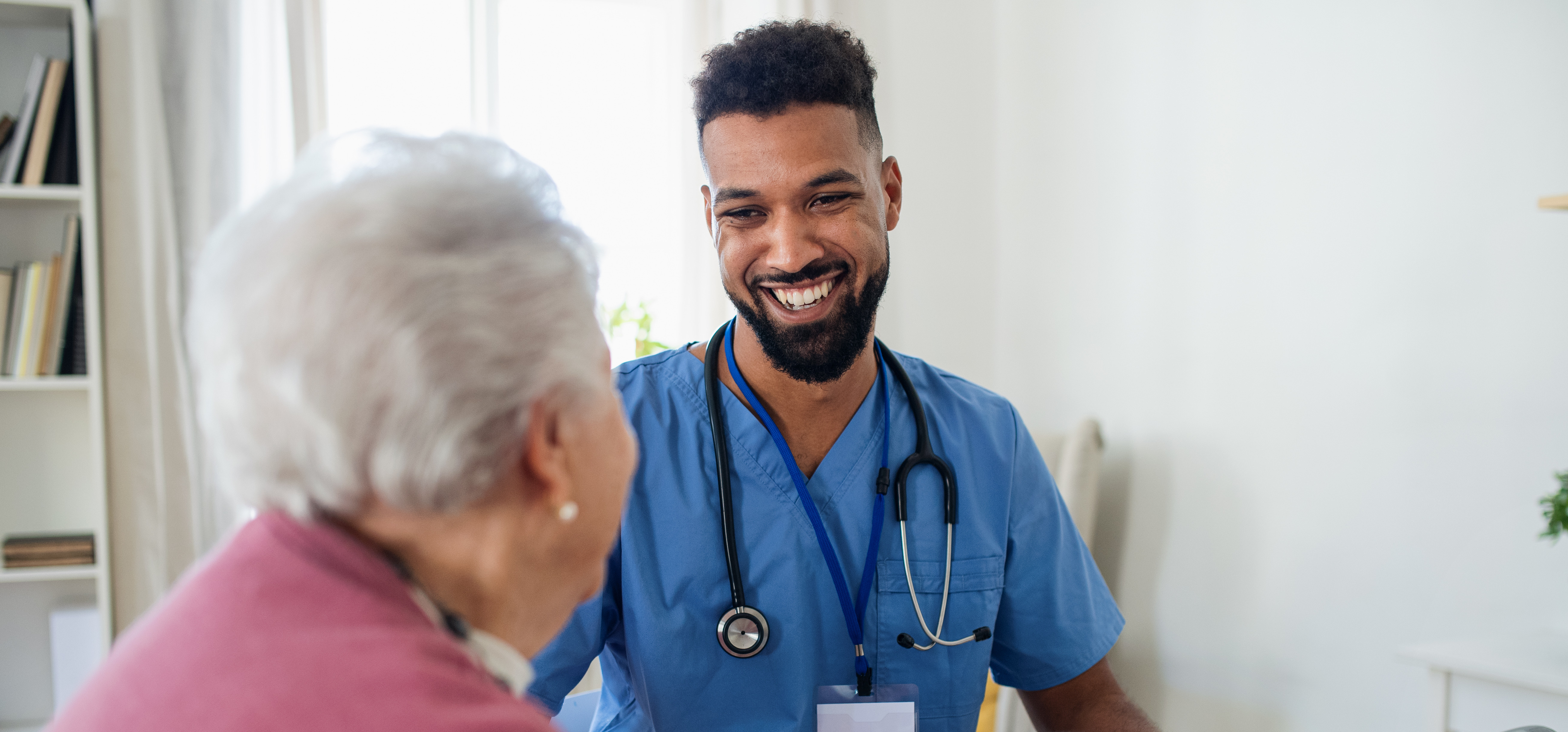 Healthcare worker talking to senior citizen